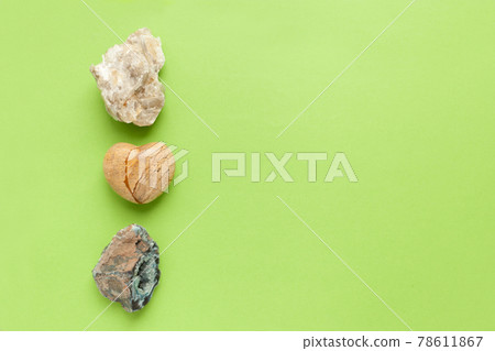 Backgrounds and textures, nature concept - rocks and minerals. Different minerals and heart stone on green background. 78611867