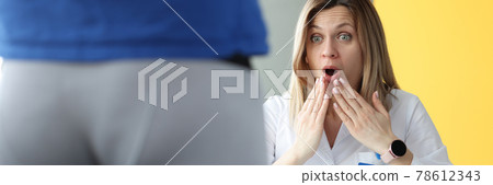 Woman doctor examining patient in shorts and is surprising Woman doctor examining patient in shorts and is surprising 78612343