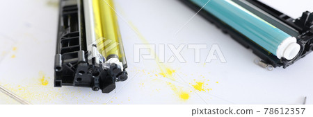 Yellow and blue cartridges for printer lying on table closeup Yellow and blue cartridges for printer lying on table closeup 78612357
