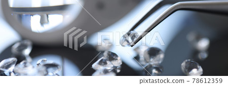 Closeup of diamond stone in metal tweezers Closeup of diamond stone in metal tweezers 78612359