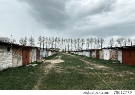 Abandoned industrial area - old closed garages, aged buildings. Selective focus 78612779