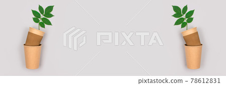 Banner with eco-friendly coffee to go cups - kraft paper cup with green leaves above on light grey background with copyspace. Recycled kraft paper packaging and zero waste concept, mockup image 78612831