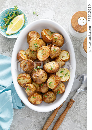 Potato halves baked with thyme, top view 78612919