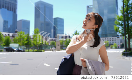 Business woman who wipes sweat when it's hot Business woman who wipes sweat when it's hot 78612921