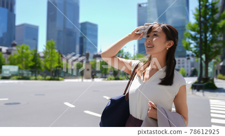 Business woman who wipes sweat when it's hot Business woman who wipes sweat when it's hot 78612925