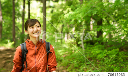 Young woman hiking in the mountains 78613083