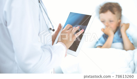 Happy smiling male kid-patient at usual medical inspection. Doctor and young boy in the clinic. Medicine concepts Happy smiling male kid-patient at usual medical inspection. Doctor and young boy in the clinic. Medicine concepts 78613260