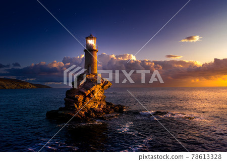 The beautiful Lighthouse Tourlitis of Chora at night. Andros island, Cyclades, Greece 78613328