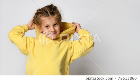Portrait of a joyful active little girl wearing a 78613860
