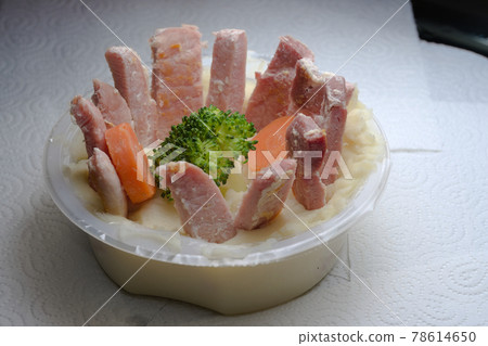 Abstract kitchen scene of comically presented food in a plastic tub 78614650