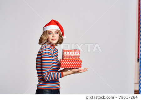 happy woman with christmas gifts in hands and red hat on head new year holidays cropped view happy woman with christmas gifts in hands and red hat on head new year holidays cropped view 78617264