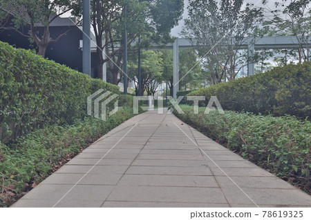 park pedestrian walkway toward modern city, hk 29 May 2021 78619325