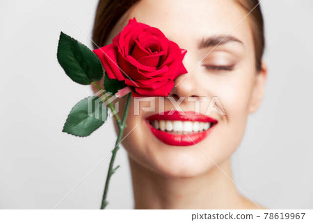 Beautiful woman with rose Face close-up smile bright makeup  78619967