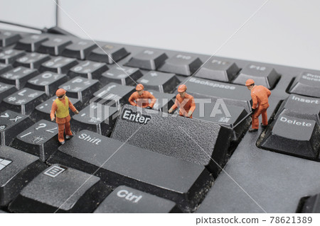 a Miniature people cleaning white keyboard computer. a Miniature people cleaning white keyboard computer. 78621389