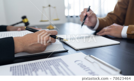 law,libra scale and hammer on the table, 2 lawyers are discussing about contract paper, law matters determination, showing paper and notes law,libra scale and hammer on the table, 2 lawyers are discussing about contract paper, law matters determination, showing paper and notes 78623464