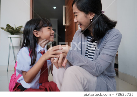 happy primary student at back home after school and talk 78623725