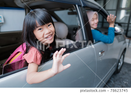 asian primary pupil student sitting in the car and waving good bye asian primary pupil student sitting in the car and waving good bye 78623745