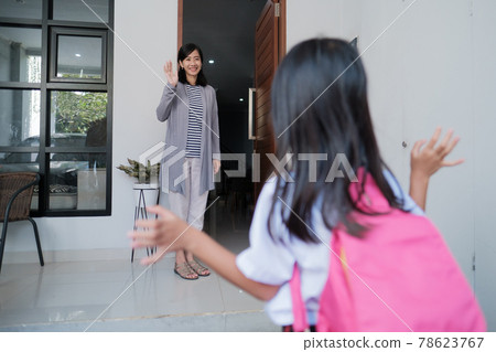 kid waving goodbye to mother at home before going to school kid waving goodbye to mother at home before going to school 78623767