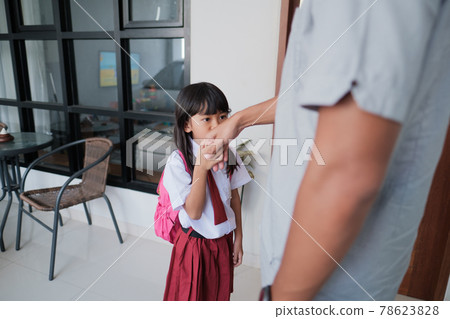indonesian primary school female student shake and kiss her father's hand before going to school indonesian primary school female student shake and kiss her father's hand before going to school 78623828