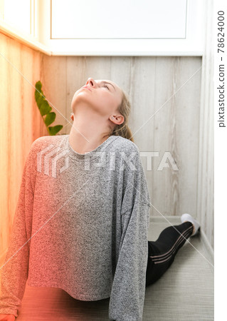 Young millennial blonde woman doing yoga exercise stretching fitness at balcony home. Mindfulness meditation. Relax breathe easy pose gym healthy lifestyle concept. 78624000