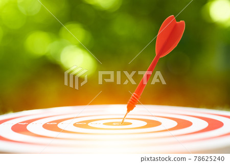 Close up red dart arrow hit the center target highest score of dartboard. Business management and planing to success go winner goal concept. 78625240