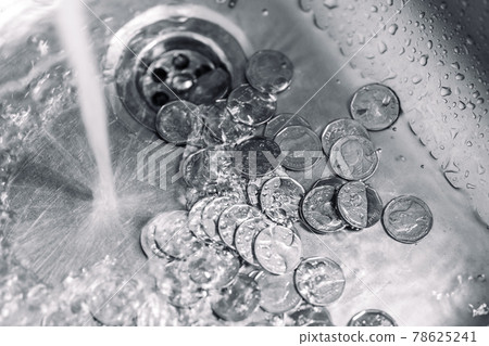 cleaning coins in wash basin sink. wasting and lost money when leaving the water open concept. high cost water utilities bill debt. cleaning coins in wash basin sink. wasting and lost money when leaving the water open concept. high cost water utilities bill debt. 78625241