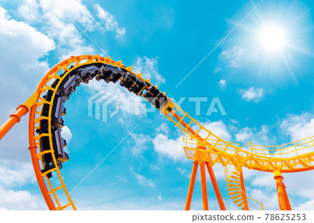 roller coaster high in the summer sky at theme park most excited fun and joyful playing machine 78625253