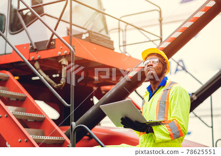 Black African port shipping staff director working in logistic using laptop to control loading containers at ship cargo for import export goods foreman looking high for future. Black African port shipping staff director working in logistic using laptop to control loading containers at ship cargo for import export goods foreman looking high for future. 78625551