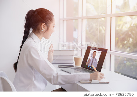Woman greeting video call with doctor from internet channel staying at home. Girl teen patient in video conferencing with general health practitioner or online personal healthcare for consult. Woman greeting video call with doctor from internet channel staying at home. Girl teen patient in video conferencing with general health practitioner or online personal healthcare for consult. 78625790