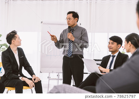 Asian businessman meeting or company conference sale report target discussion. Professional manager talking to young new staff for business planning and training. 78625797