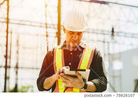 Foreman builder engineer worker using tablet computer to check building floor plan at construction site. Foreman builder engineer worker using tablet computer to check building floor plan at construction site. 78626107