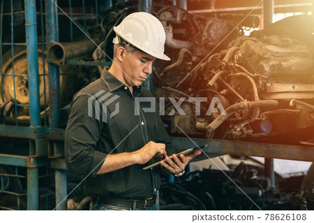 Professional adult Engineer male attending duty work in factory working checking stock inventory data with tablet computer Professional adult Engineer male attending duty work in factory working checking stock inventory data with tablet computer 78626108