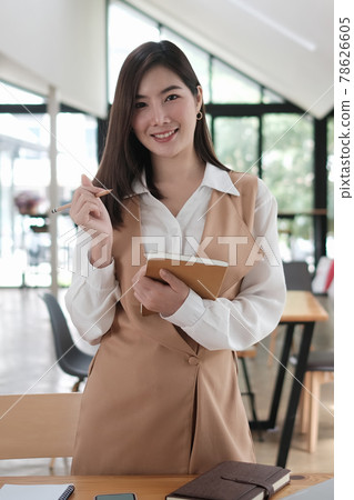 Portrait of successful female in formal wear enjoying work day smiling at camera. Portrait of successful female in formal wear enjoying work day smiling at camera. 78626605