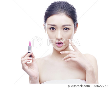young asian woman applying lipstick, isolated on white background 78627238