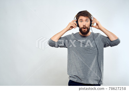 Man in headphones listens to music lifestyle modern style technology light background 78627258
