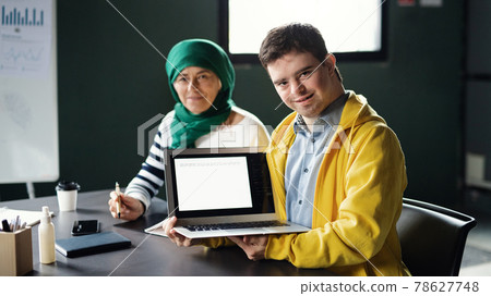 Down-syndrome man attending education class in community center, inclusivity of disabled person. 78627748
