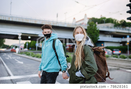 Happy young couple travelers sightseeing in city on holiday, coronavirus concept. Happy young couple travelers sightseeing in city on holiday, coronavirus concept. 78628161