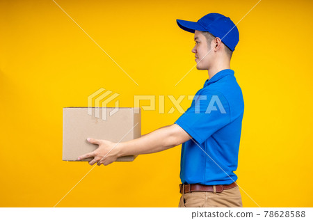 Asian delivery man holding pizza or parcel box over yellow isolate background. Work from home and delivery concept. Asian delivery man holding pizza or parcel box over yellow isolate background. Work from home and delivery concept. 78628588