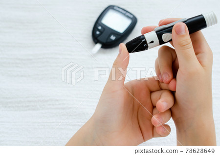 Diabetes and Glycemia. Blood sugar testing, child finger lancet punctures. Diabetes and Glycemia. Blood sugar testing, child finger lancet punctures. 78628649