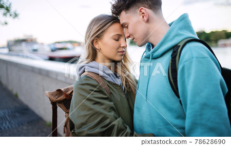 Happy young couple travelers in love in city on holiday, hugging. Happy young couple travelers in love in city on holiday, hugging. 78628690