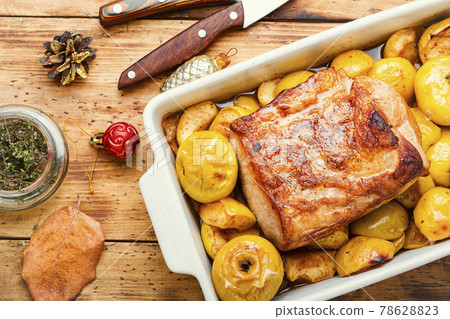 Baked pork with apples 78628823