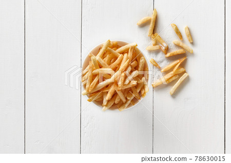 Crispy french fries in bowl on white wooden background Crispy french fries in bowl on white wooden background 78630015