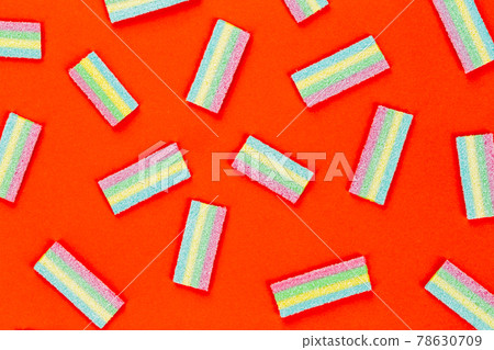 Licorice Candy. Sweet gummy sticks with different flavor, on red background. Licorice Candy. Sweet gummy sticks with different flavor, on red background. 78630709