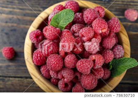 Fresh raspberry in a wooden plate. Fresh raspberry in a wooden plate. 78630710