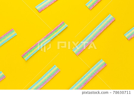 Licorice Candy. Sweet gummy sticks with different flavor, on yellow background. Licorice Candy. Sweet gummy sticks with different flavor, on yellow background. 78630711