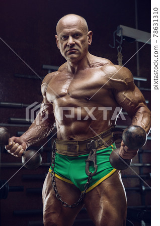 Old fashion bodybuilder arm exercises in gym Old fashion bodybuilder arm exercises in gym 78631310