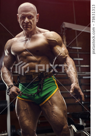 Old fashion bodybuilder arm exercises in gym 78631313