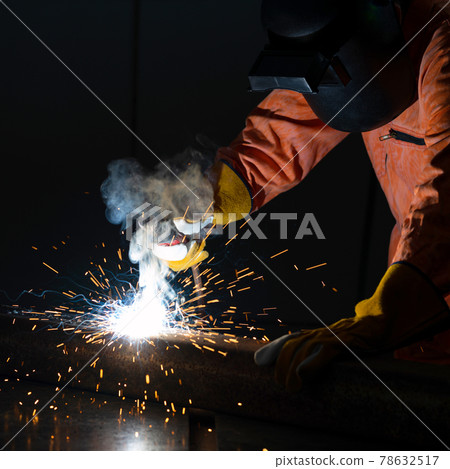 Metal industry workers are welding steel sheets for real estate projects received. Sparkler on black background, close-up. Heavy work in factory. Metal industry workers are welding steel sheets for real estate projects received. Sparkler on black background, close-up. Heavy work in factory. 78632517