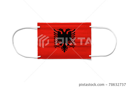 Flag of Albania on a disposable surgical mask. White background Flag of Albania on a disposable surgical mask. White background 78632737