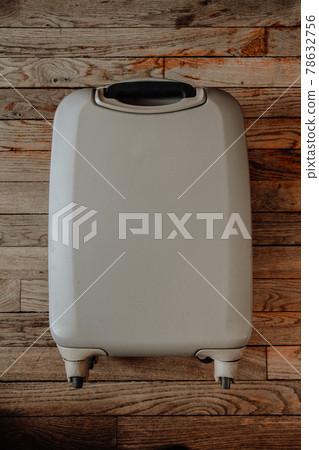 Vintage suitcase isolated on old wooden background 78632756